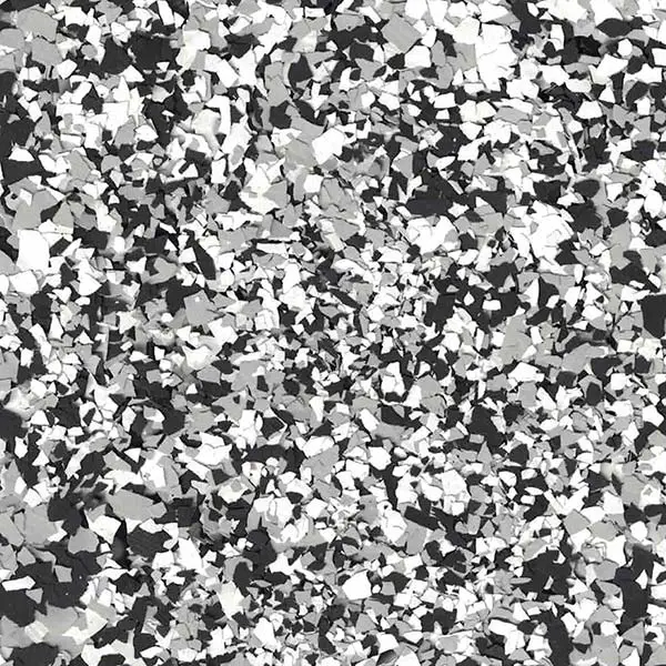 A close-up of a random pattern featuring black, white, and gray chips scattered across a surface, forming an abstract, textured design.