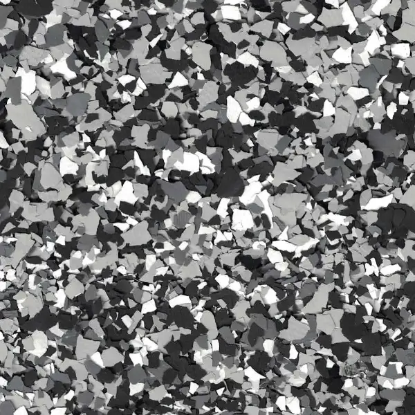 The image shows a textured surface with scattered black, white, and gray flakes creating an abstract pattern. No landmarks or historical buildings are present.